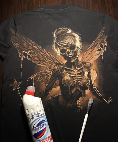 Hand-painted Skeleton Fairy Tinkerbell bleach art design on a black T-shirt
