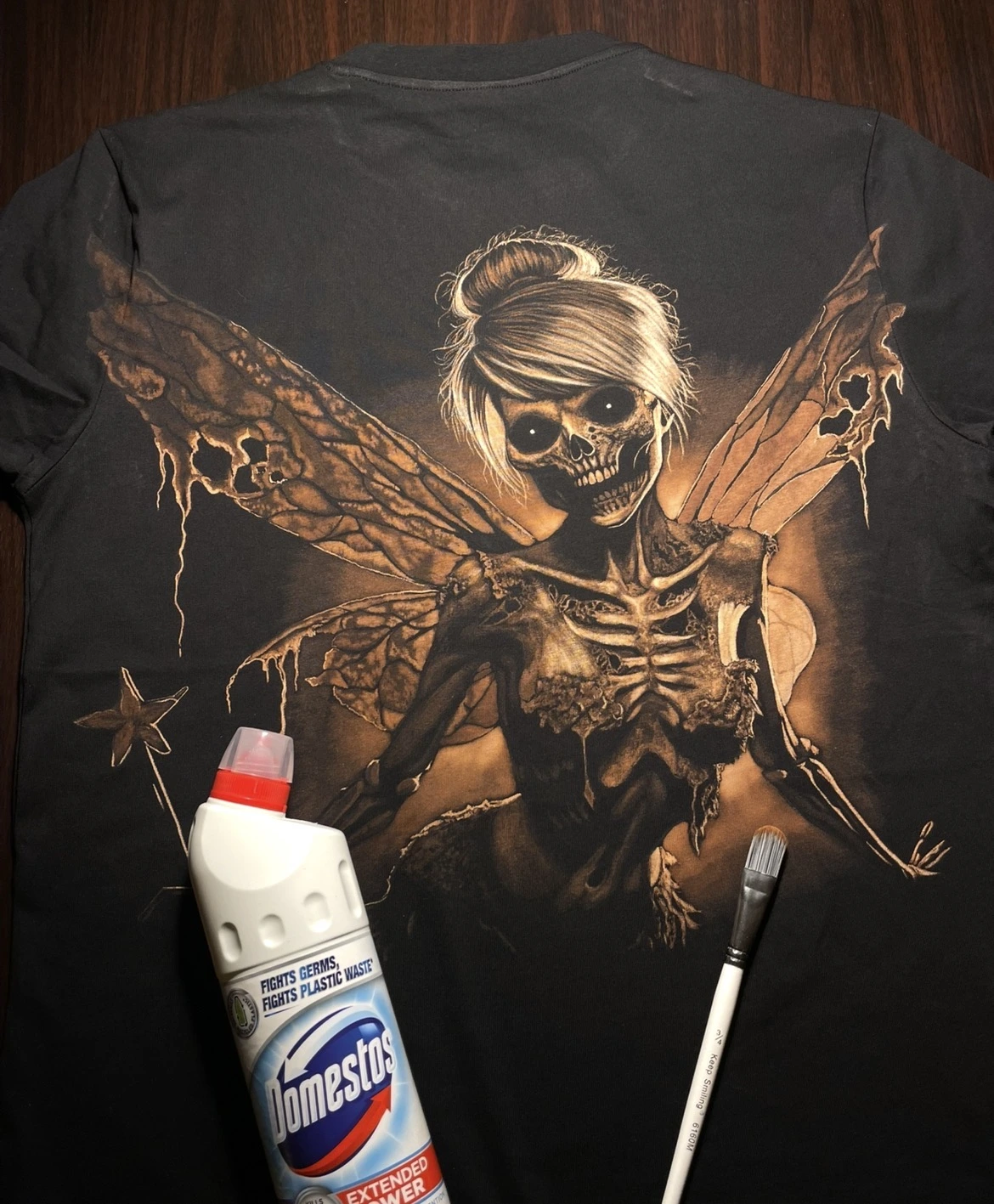 Hand-painted Skeleton Fairy Tinkerbell bleach art design on a black T-shirt