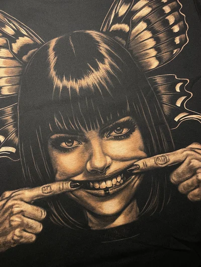 Handmade bleach art smile design close-up on black cotton t-shirt