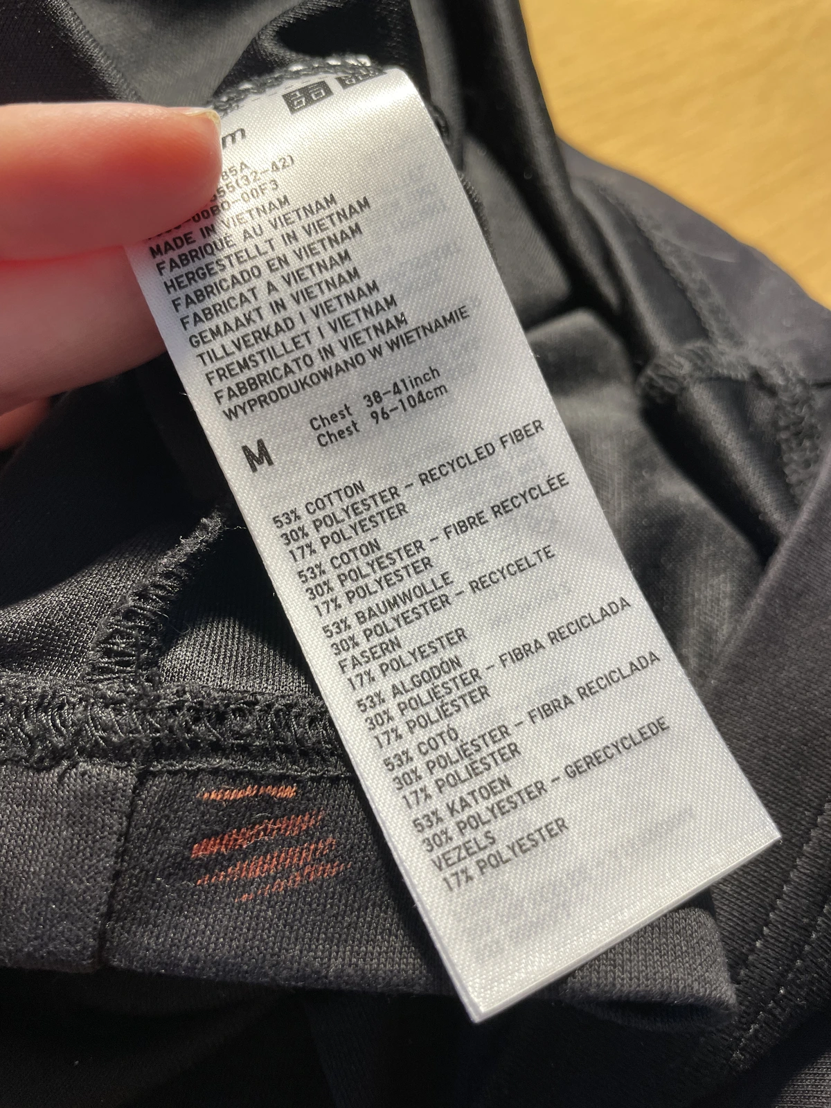 Small bleach test line on black Uniqlo cotton polyester blend shirt fabric