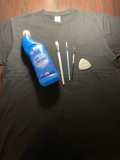 Collection of handmade bleach art designs on black clothing