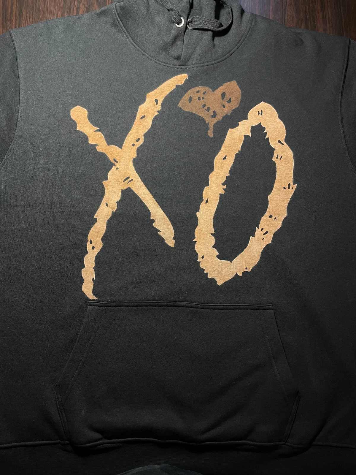 Small minimalist bleach art drawing on black clothing