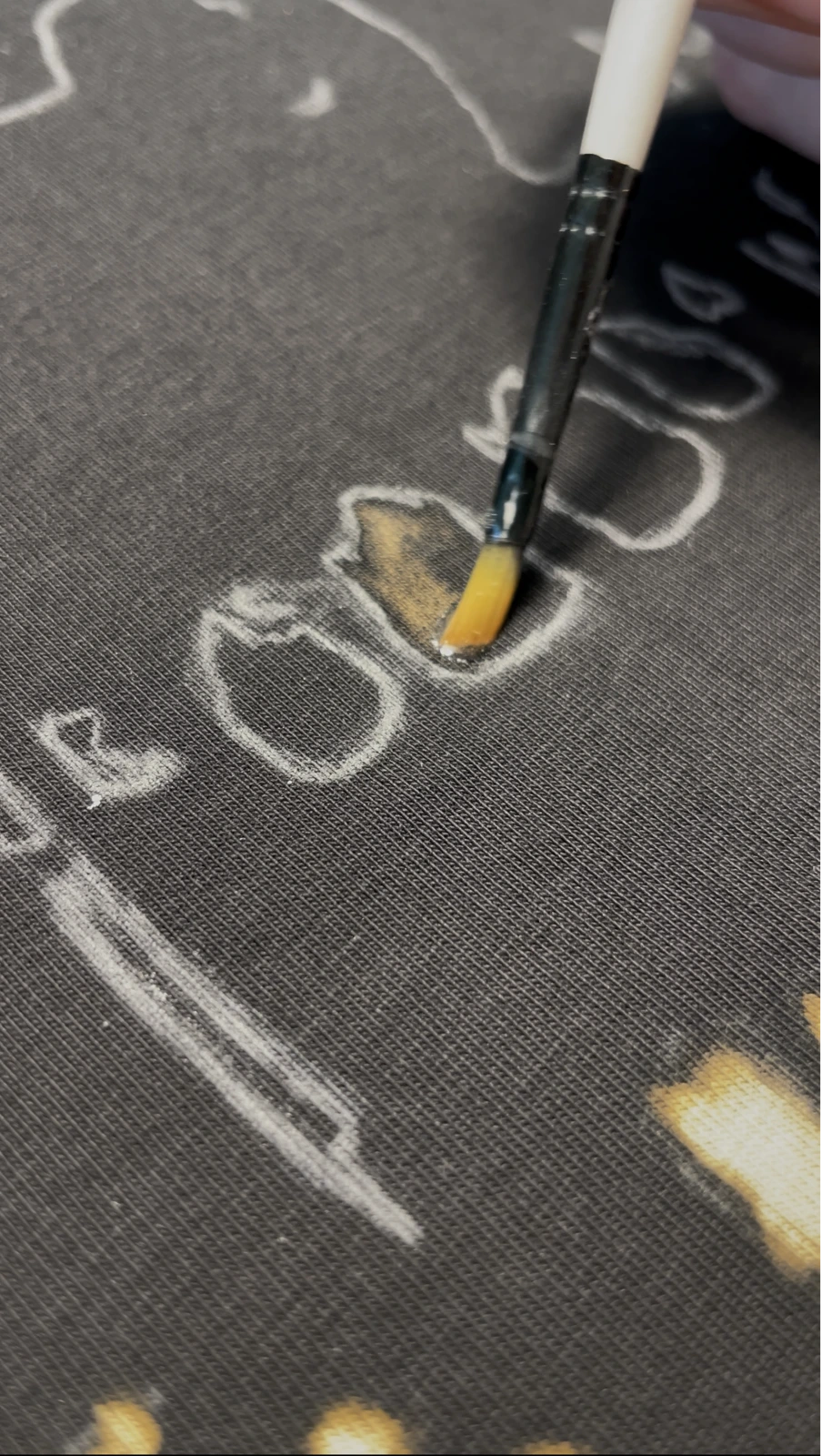Hand painting with bleach on black cotton fabric