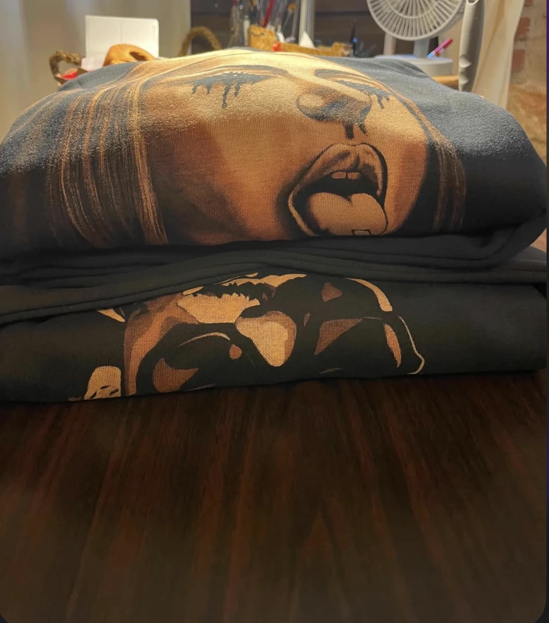 Soft folded bleach art hoodie showing flexible fabric and natural drape