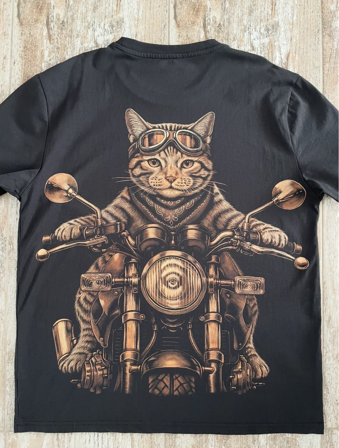 Cat riding a motorcycle in an animal bleach art design on a black T-shirt
