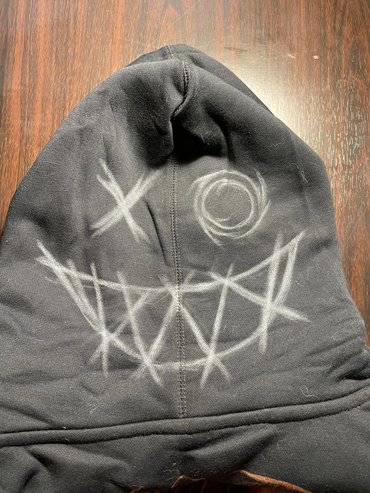 Chalk sketch on hoodie hood for custom bleach art design