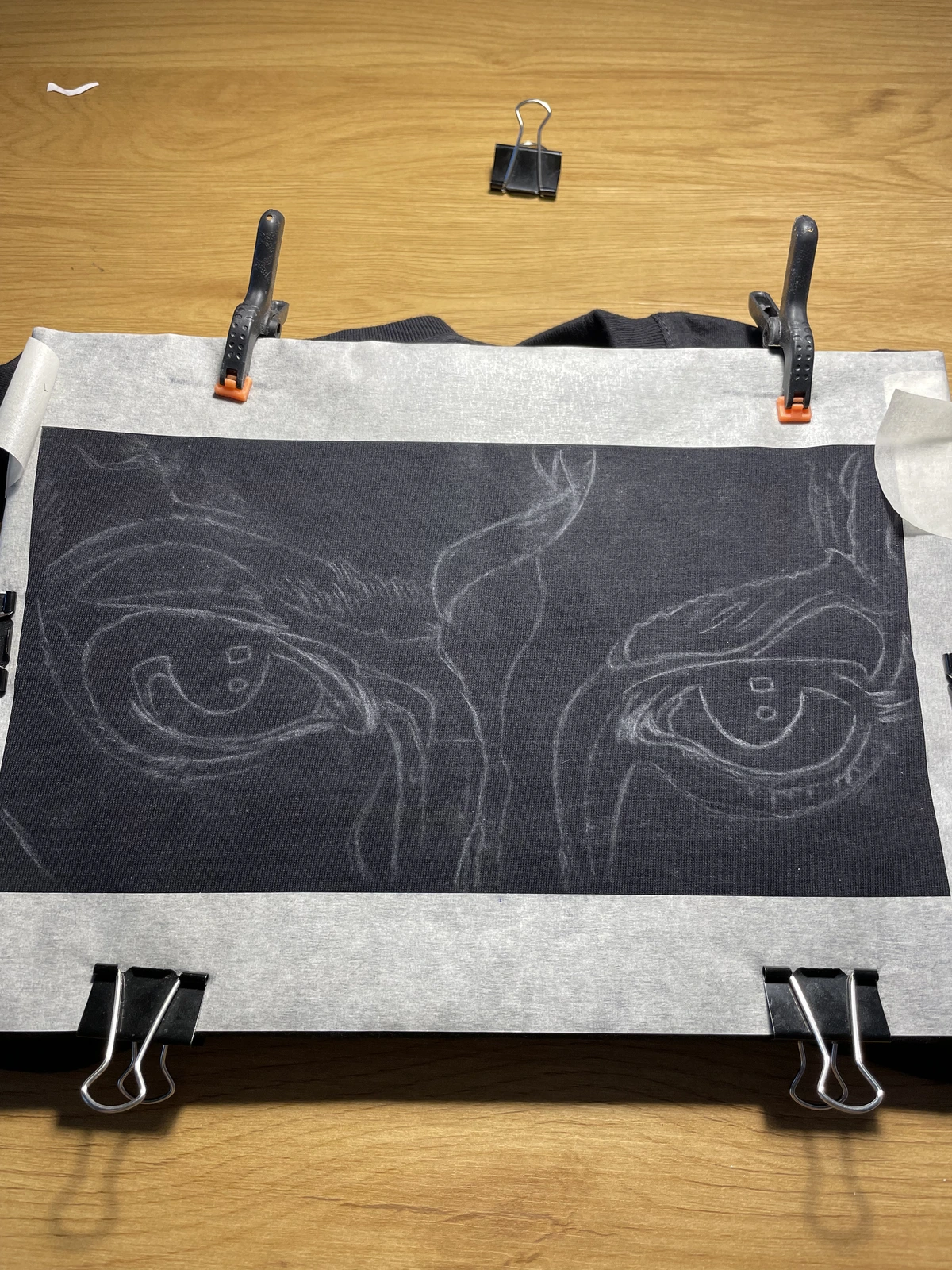 Chalk sketch prepared on a black T-shirt for custom bleach painting