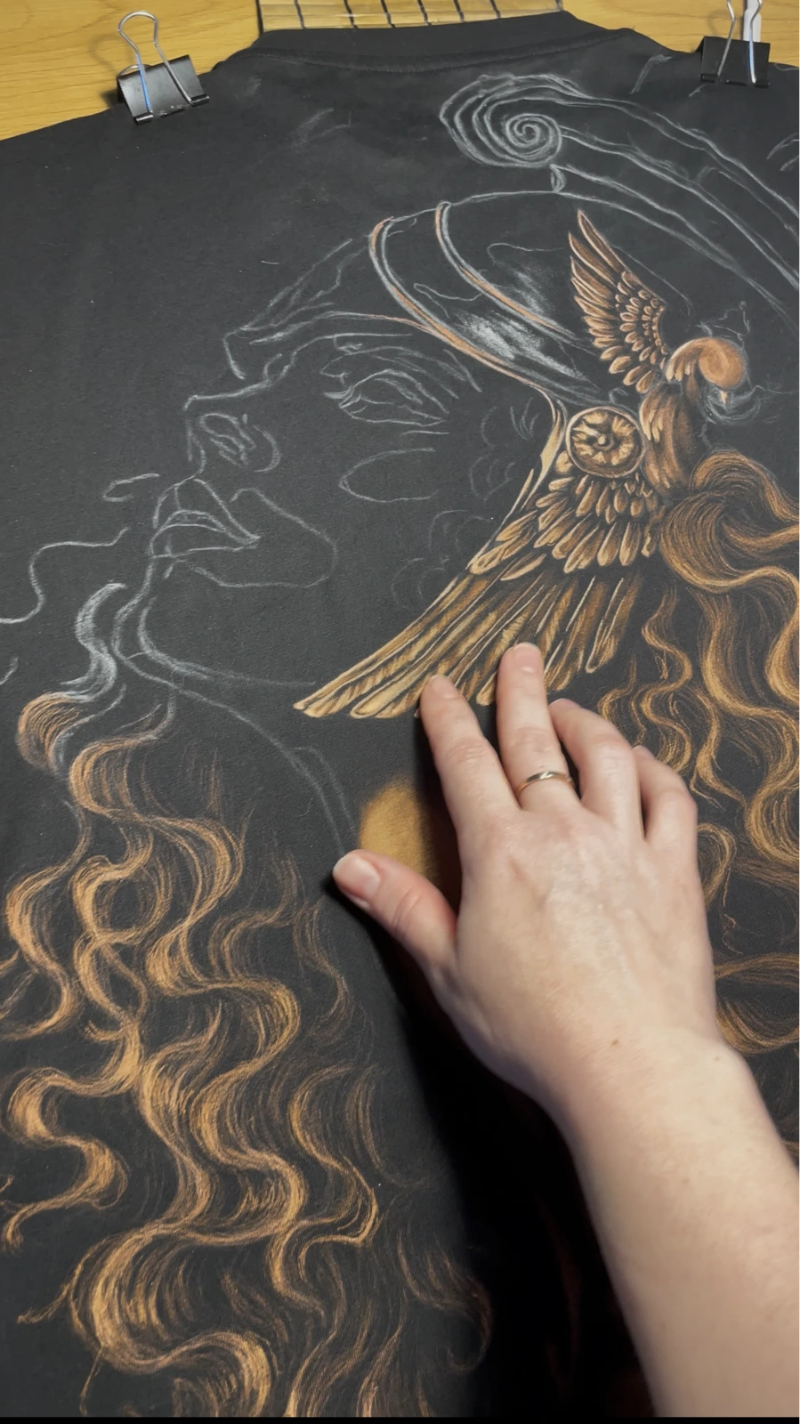 Close-up texture of hand-painted bleach art on black cotton fabric