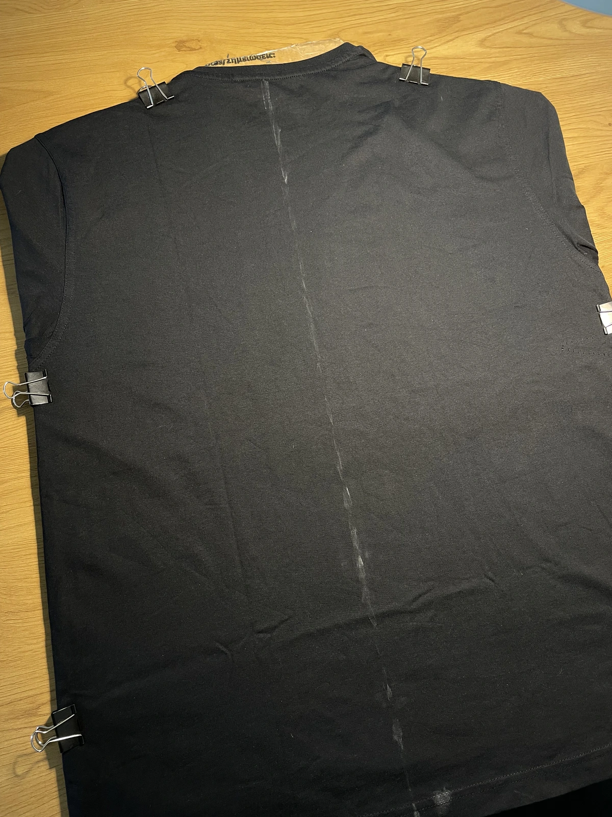 Cardboard placed inside a black shirt before bleach painting