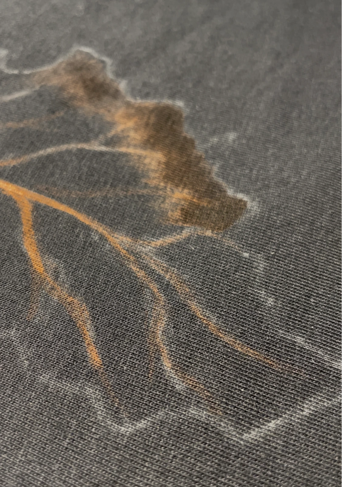 Close-up of detailed bleach lines on black fabric