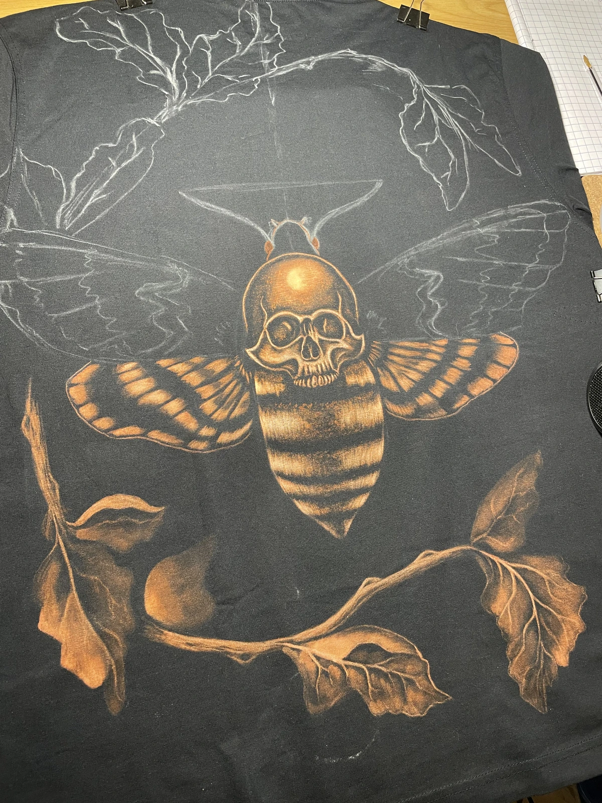 Half finished bleach design on a black shirt