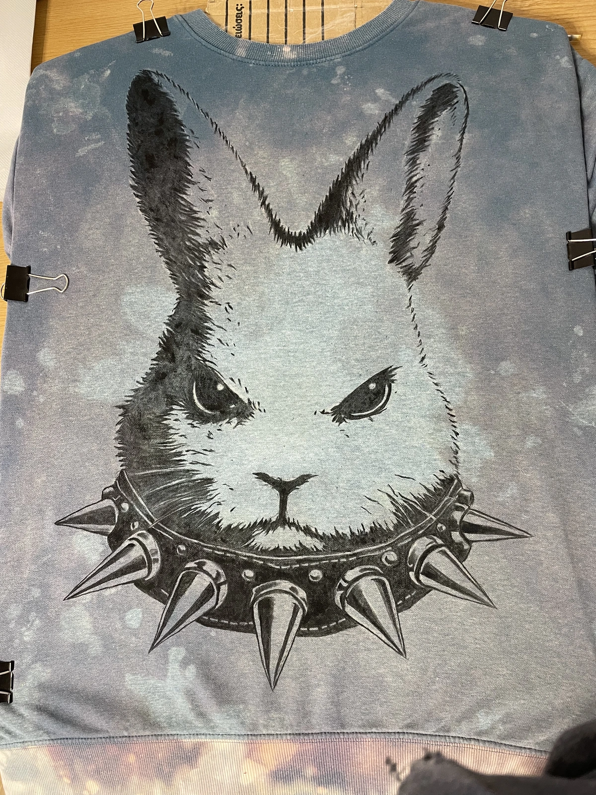 black fabric paint applied over bleach stain design on sweatshirt