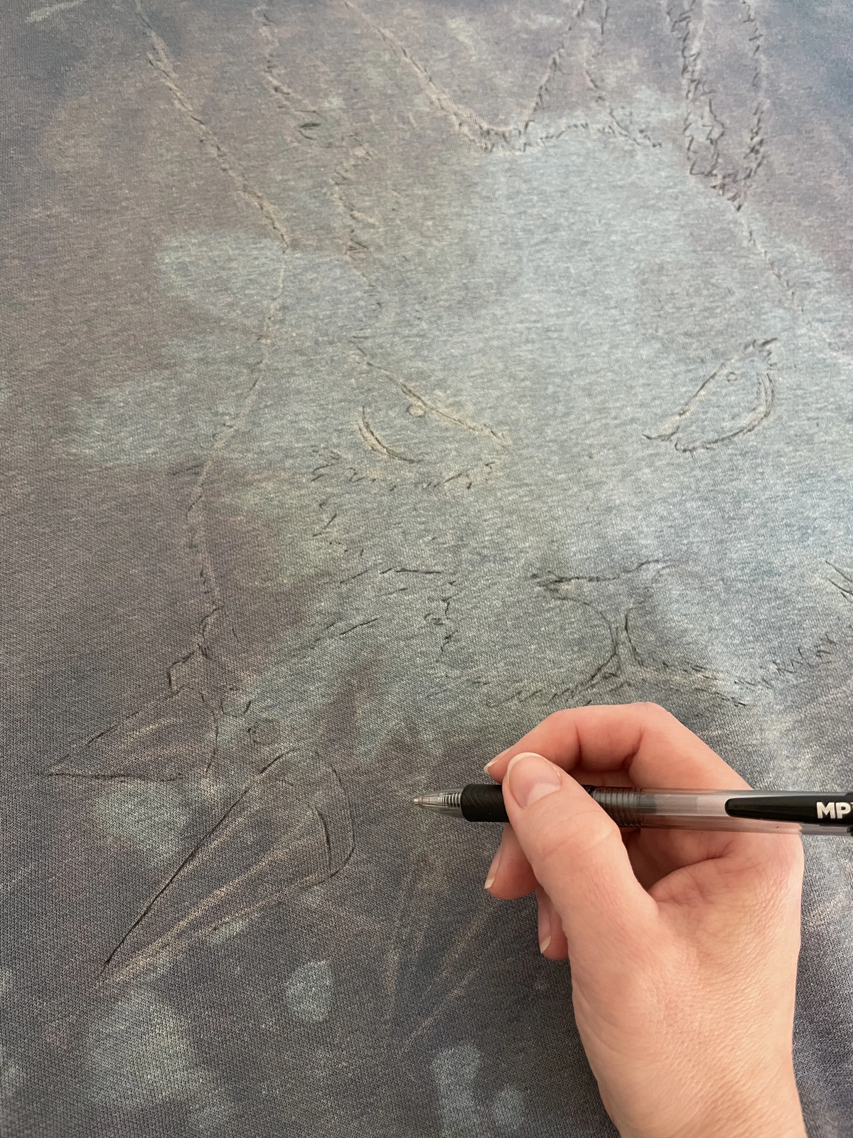 rabbit sketch drawn over bleach stained sweatshirt fabric