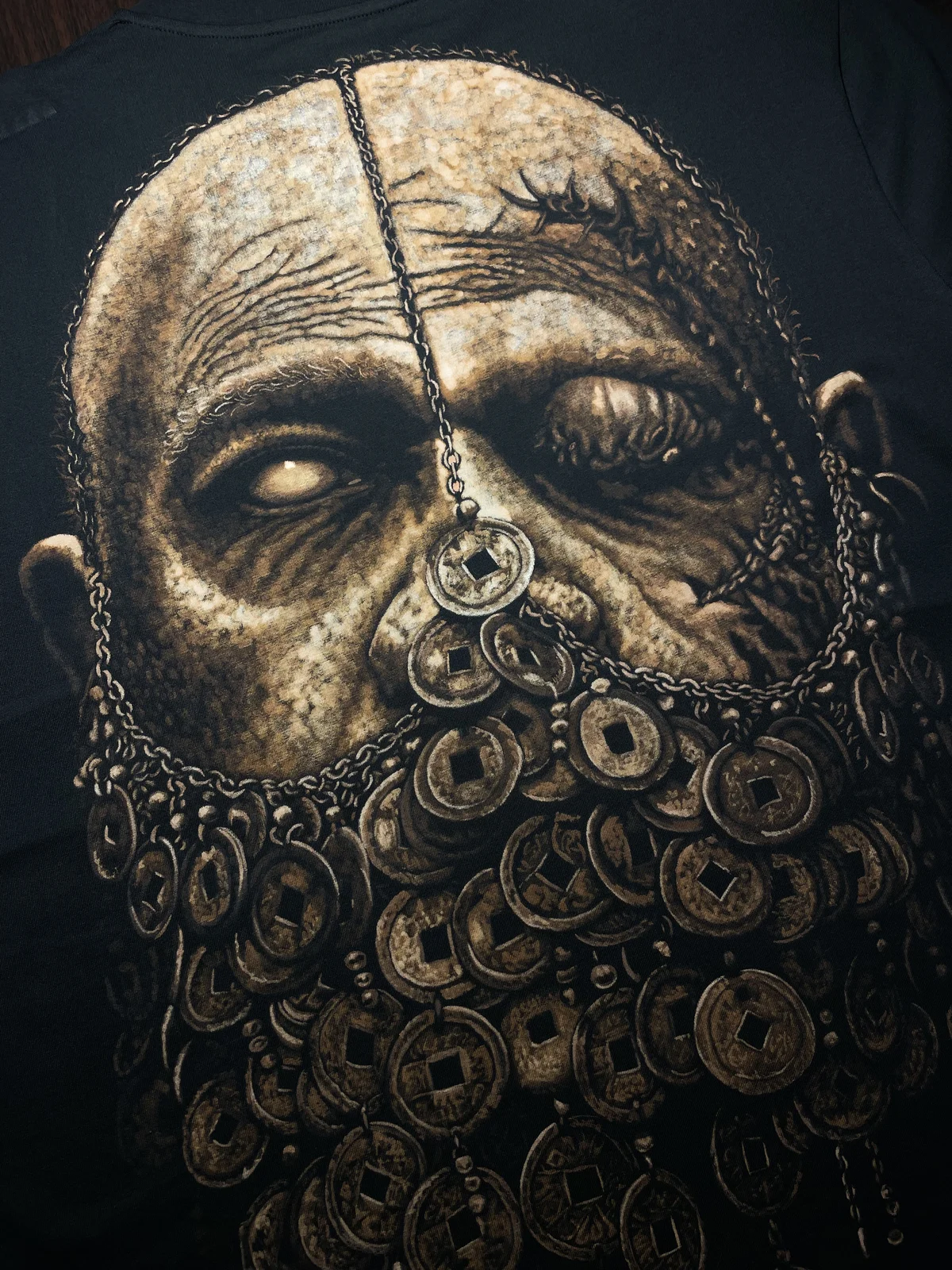 Close-up of handmade bleach art design on black t-shirt