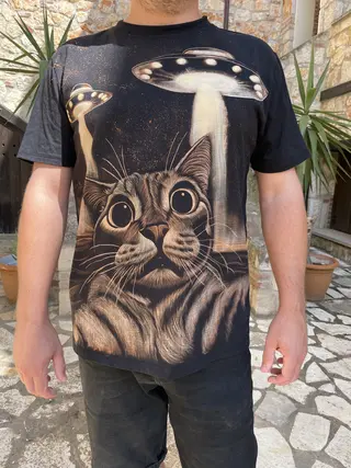 Bleach art t-shirt worn by a model featuring a cat and UFO illustration