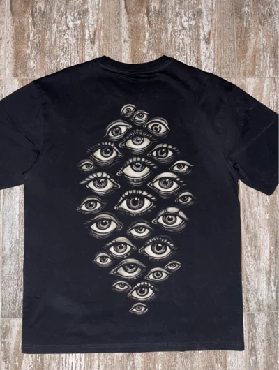Multiple evil eye symbols on back of occult bleach art t-shirt, protective gothic eye design