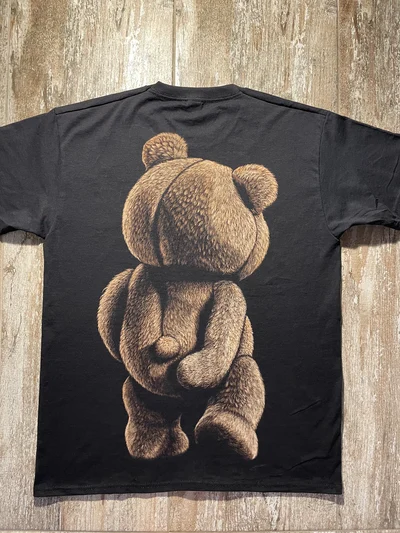 This hand-painted Ted movie bleach T-shirt features a large teddy bear bleach art design created with real bleach on a black unisex bleached graphic tee.