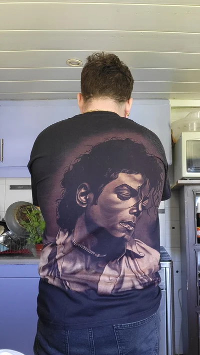 Back view of customer wearing a handmade Michael Jackson bleach art shirt featuring a detailed portrait on the back