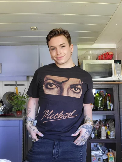 Happy customer wearing a custom hand-painted Michael Jackson bleach art T-shirt with Michael lettering and front portrait design