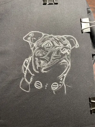 Chalk sketch of small American Staffordshire Terrier portrait on front of T-shirt