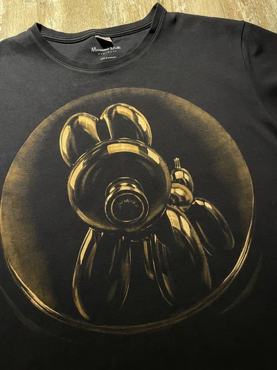 Detailed bleach art balloon dog artwork hand-painted on a black cotton T-shirt with realistic highlights and contrast