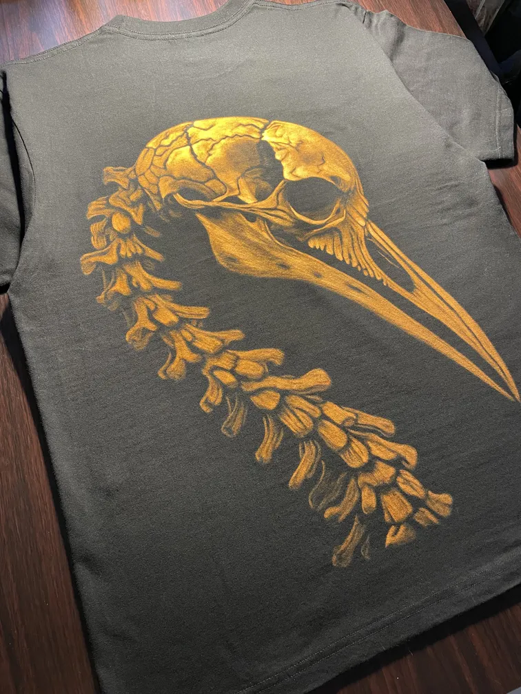 Bird skeleton bleach art illustration covering the back of a black t-shirt
