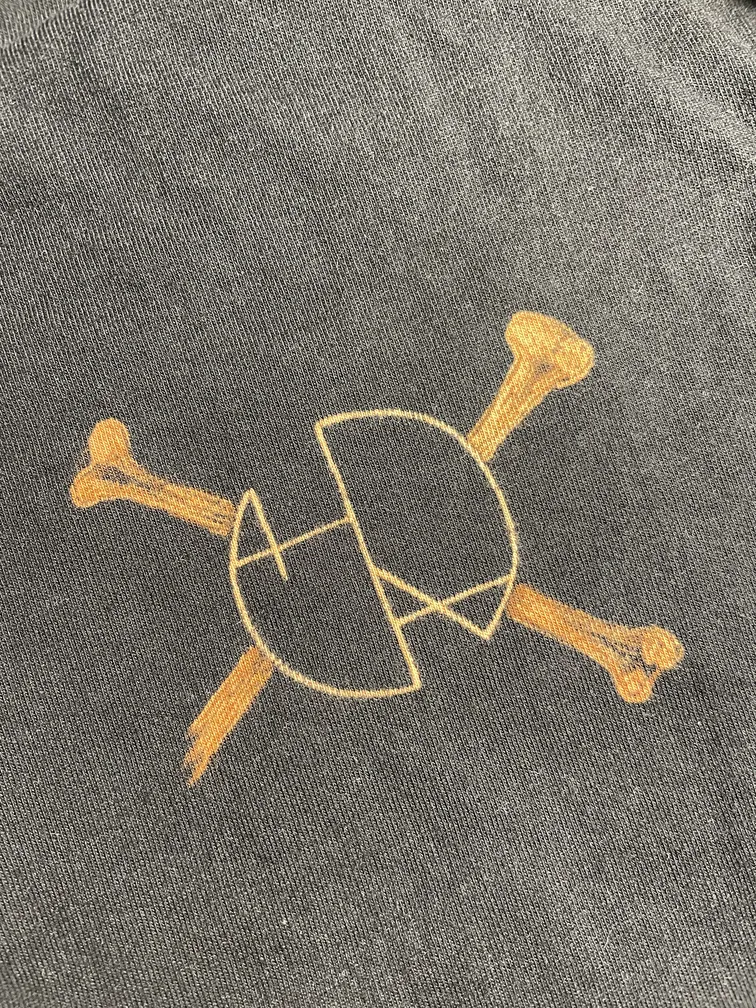 Close-up of the Helen Oben Art logo on the front of the t-shirt