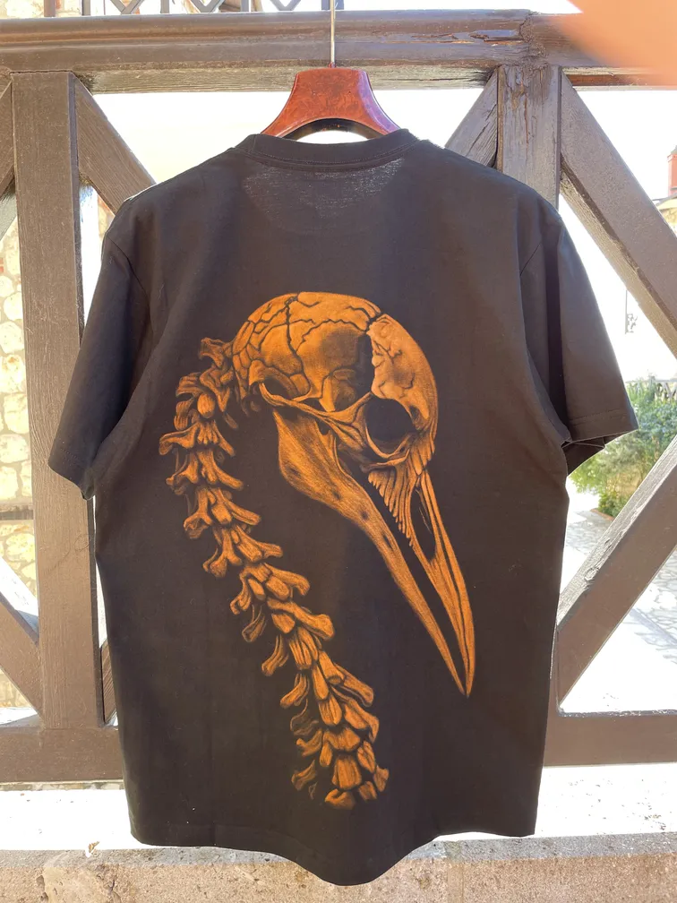 Daylight close-up of a bird skeleton illustration in bleach art style on a t-shirt