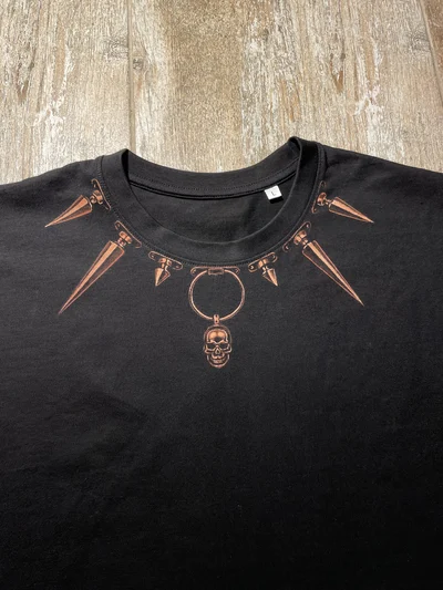 Close-up of the bleach-painted spikes forming a collar around the T-shirt neckline