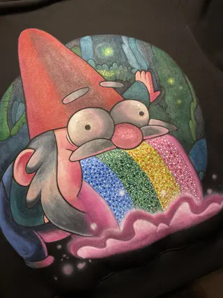 Close-up of a colorful rainbow gnome artwork painted with acrylics on a hoodie