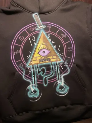 Front view of a hoodie featuring a triangle eye character inspired by Bill Cipher