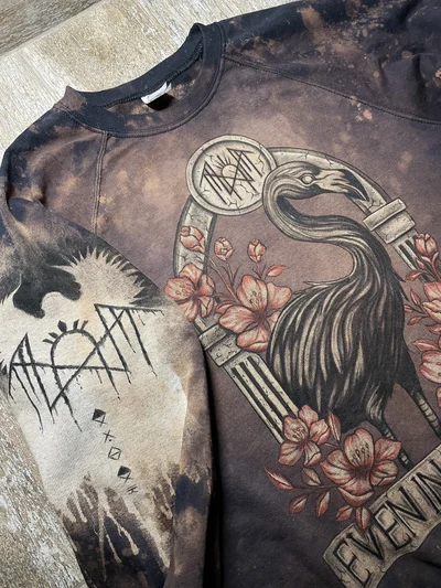 Angled front view of the Sleep Token sweatshirt showing the flamingo design and painted sleeve symbols