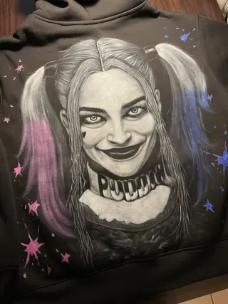 Harley Quinn–inspired hand-painted illustration covering the back of a winter fleece hoodie