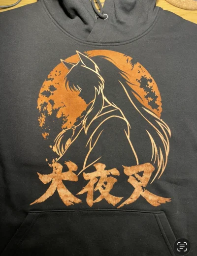 Closer front view of the Inuyasha silhouette with a distressed circular background and Japanese lettering