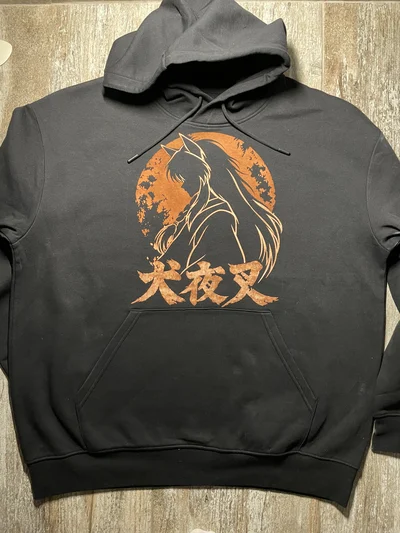Full front view of a black Inuyasha anime hoodie with a smaller bleach art design above the kangaroo pocket