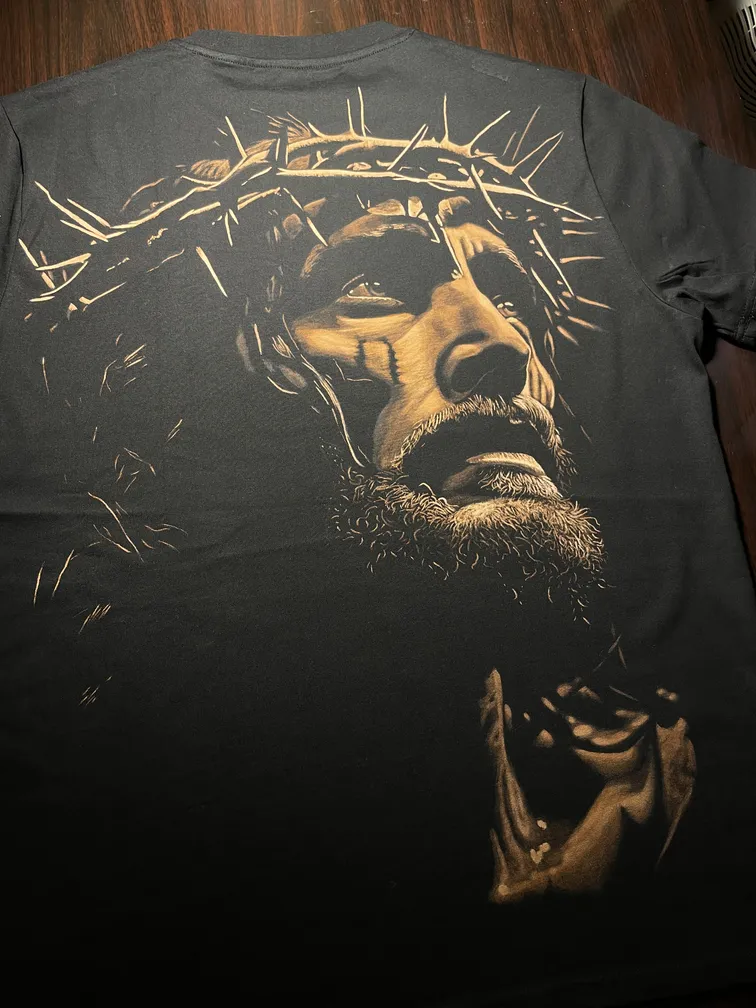 Angled view of a Jesus bleach art design on the back of the t-shirt