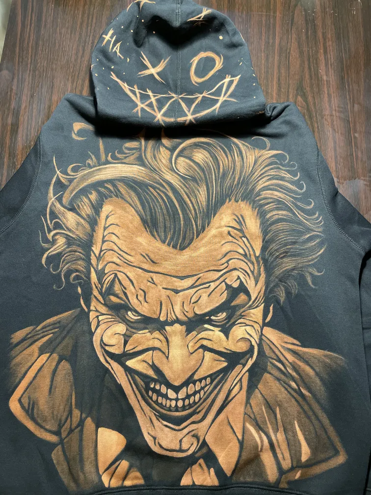 Joker-inspired villain bleach art illustration covering the back and hood of a fleece hoodie