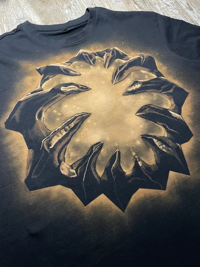 Close-up of the handmade Aegis of the Immortal bleach art design on the front of a black Dota 2 T-shirt