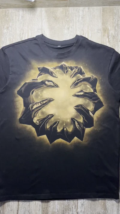 Video showing the full front of a black oversized T-shirt with a handmade Aegis of the Immortal bleach art design