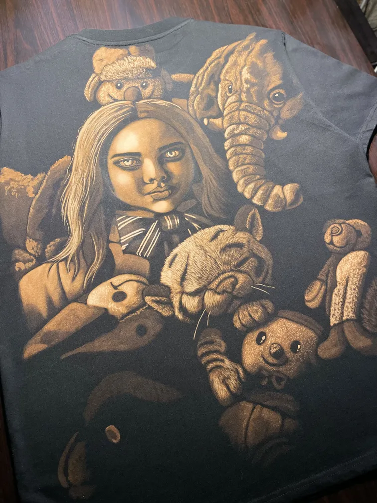 Full view of a t-shirt with a dark horror doll bleach art design on the back