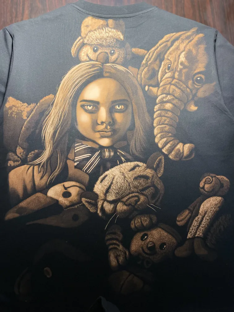 Horror doll–inspired bleach art illustration covering the back of a black t-shirt