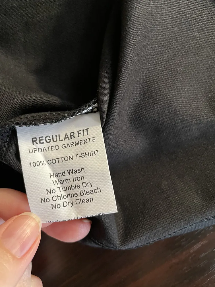 Close-up of the fabric composition label showing 100% cotton