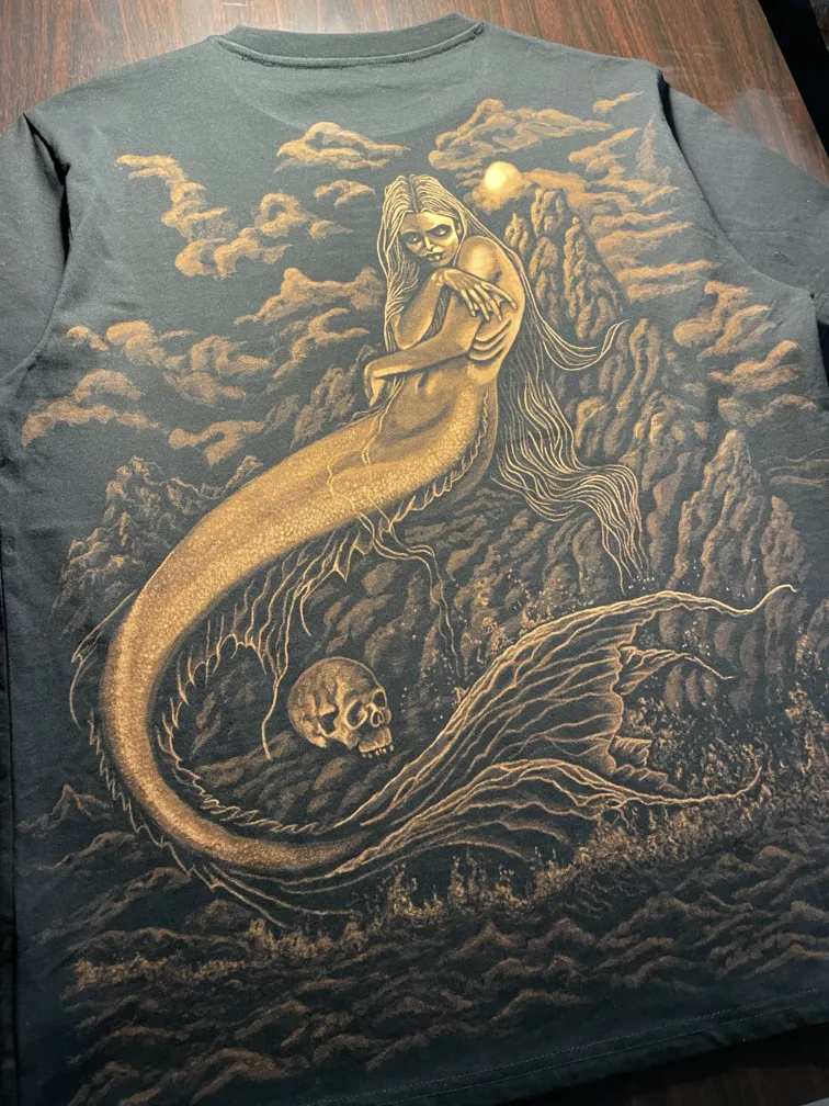 Mermaid bleach art illustration rising from dark sea on the back of a t-shirt