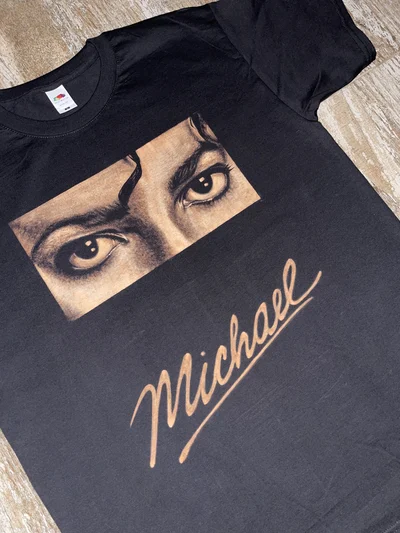 Detailed view of the Michael Jackson eyes design on a hand-painted bleach art T-shirt