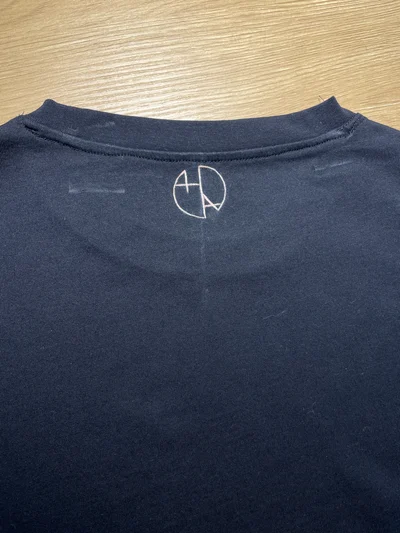 Hand-painted Helen Oben Art logo under collar on black bleach art T-shirt