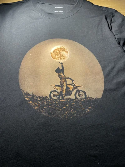 Side angle view of black motorcycle bleach art T-shirt with moon rider design