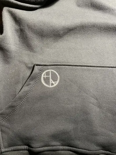 Chalk-drawn Helen Oben Art logo on the pocket of hoodie
