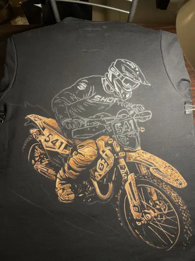 Process of creating a hand painted bleach art motorcycle racer on hoodie