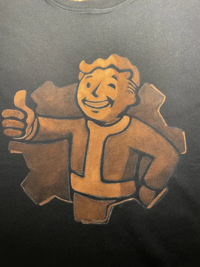 Close-up of a retro nuclear mascot illustration on the front of a t-shirt