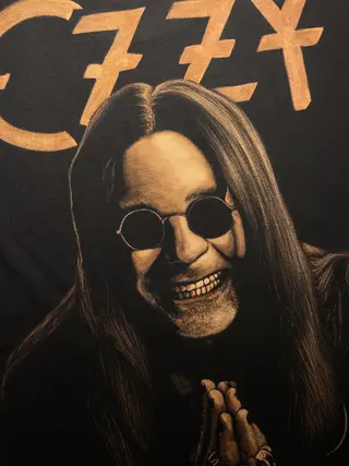 Close-up of hand painted bleach art portrait of Ozzy Osbourne on T-shirt